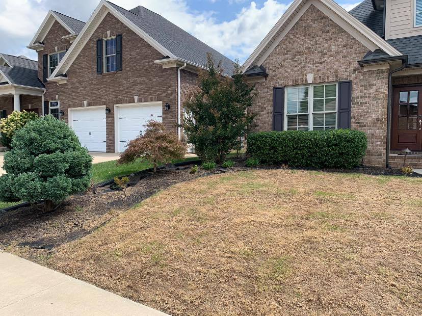 A home with landscaping by Hobgood Landscaping